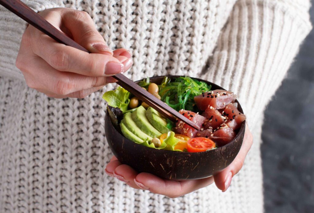 Image showing common ingredients found in poke bowls, such as diced fish, rice, and toppings.
