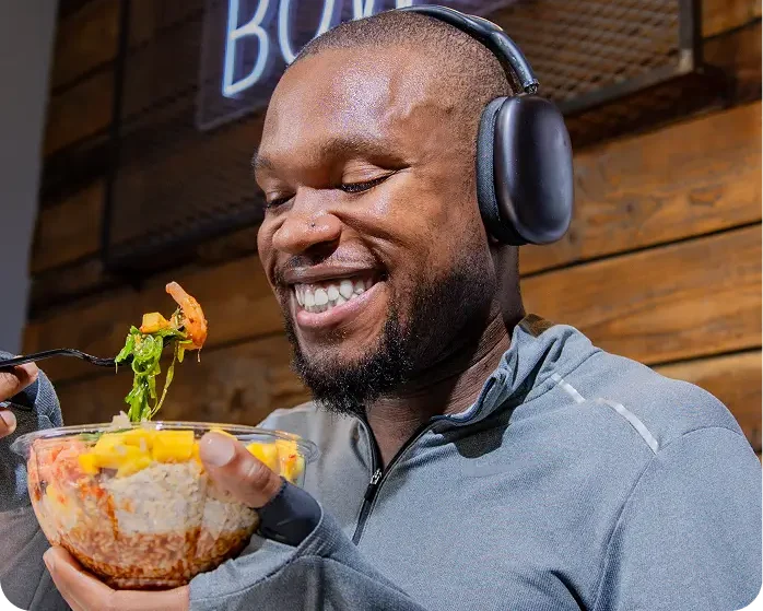 Man enjoying a poke bowl at Poke Bowl NY in Bryant Park.