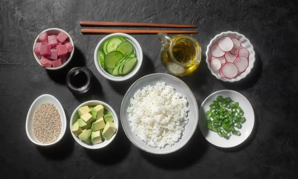 Tuna poke bowl ingredients: tuna, rice, cucumber, radish, avocado, soy sauce, sesame, green onions, sesame oil.
