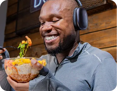 Man enjoying gluten-free Hawaiian-style poke bowl