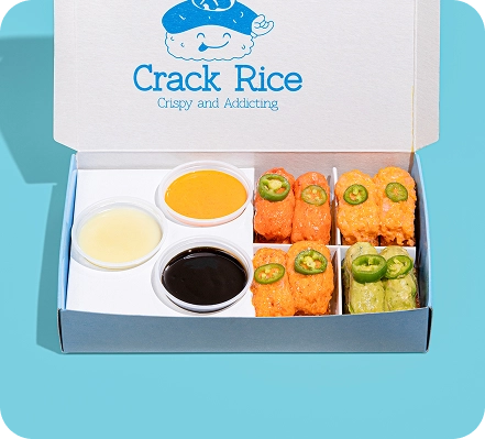 Crack Rice box with six crispy rice bites, jalapeños, three dipping sauces