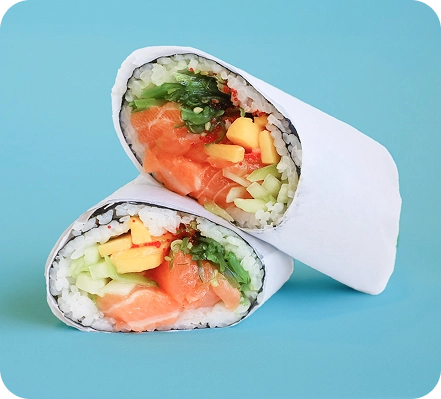 Crack Rice Mix sushi burrito halves with salmon, mango, cucumber