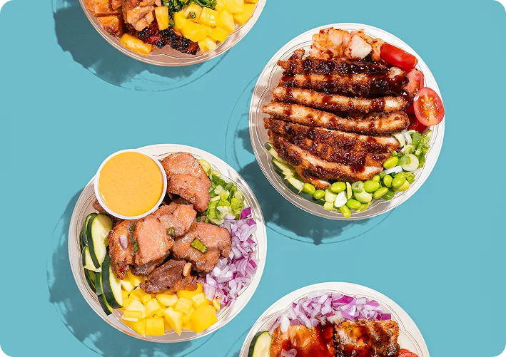 Assorted Hawaiian poke bowls arranged for catering on teal background