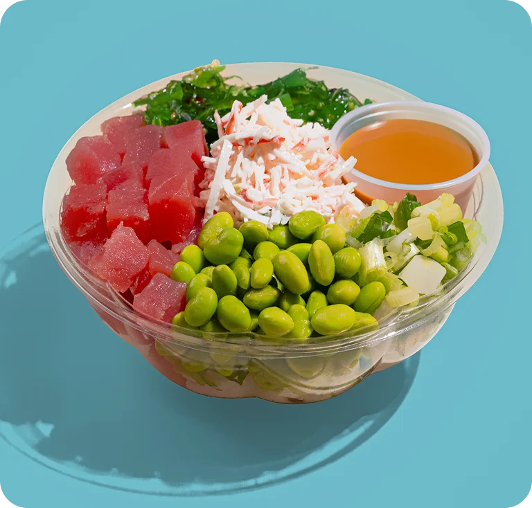 Keto poke bowl with diced tuna, edamame, shredded crab, seaweed salad, and dressing